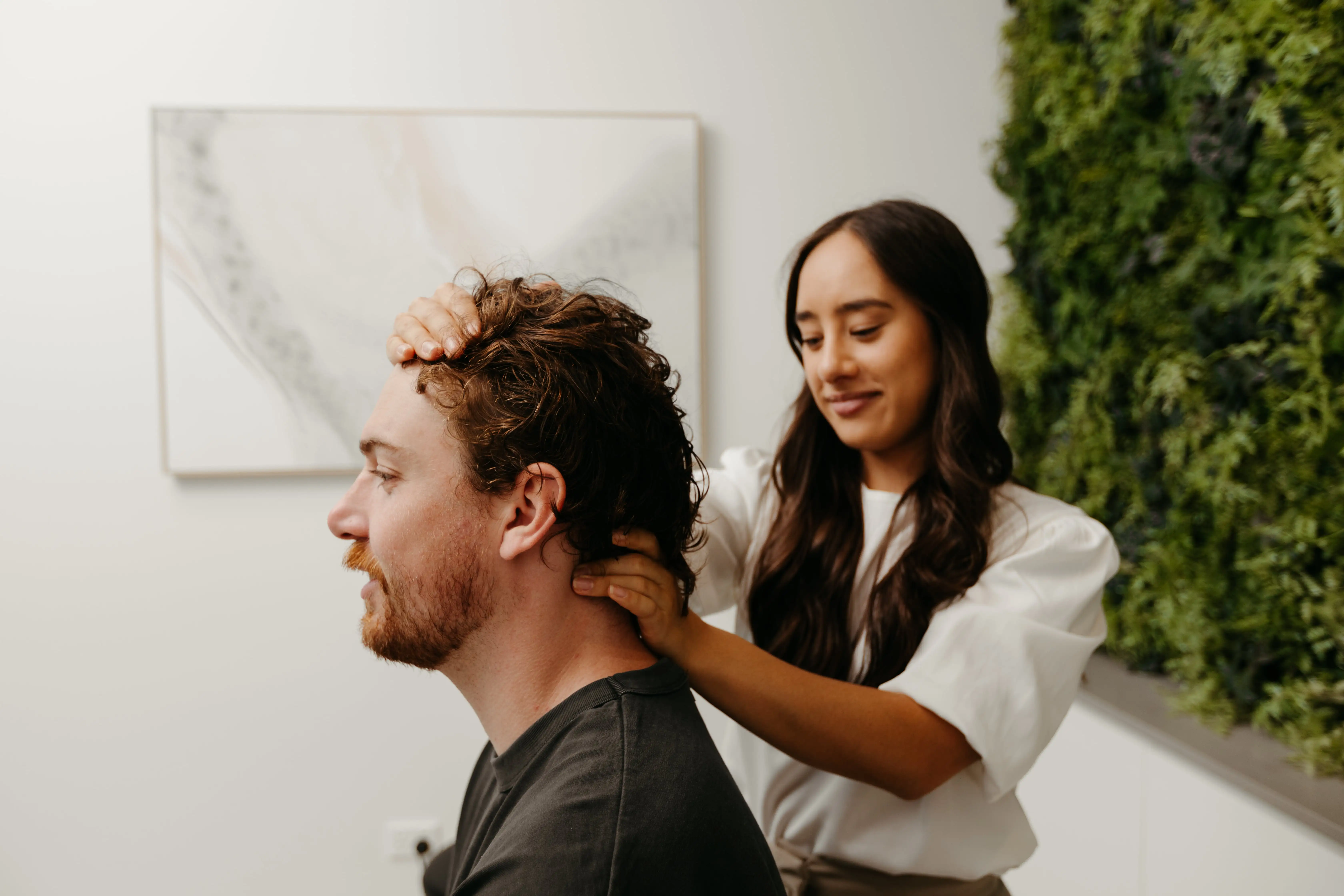 Hannah performing a gentle adjustment on a patient