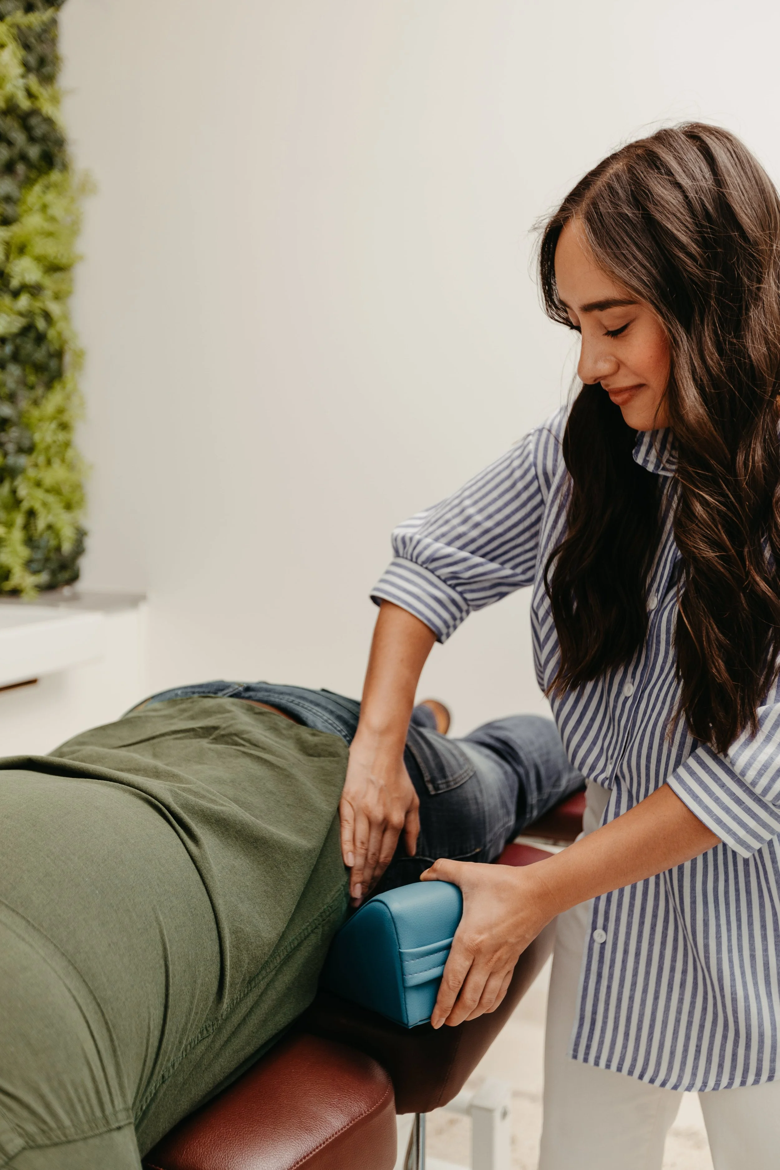 Hannah demonstrating her trauma-informed approach to chiropractic healing